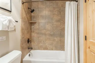 a bathroom with a tub and a toilet and a shower at Updated1849 Townhome #611, Steps to Canyon Lodge 4 Bed/3BA, hot tubs, game rm, sauna! in Mammoth Lakes