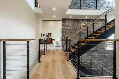 a staircase in a room with a brick wall at New Luxury Free Standing 4BR 4 and a halfBA Home Obsidian Reserve #146 Priv Hot Tub, 2-Car Garage Great Views in Mammoth Lakes