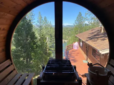 a view from the inside of a building with a large window at Lakeview Yosemite 3B2b Private House - Panoramic Sauna - Seasonal Hot Tub Jacuzzi in Groveland