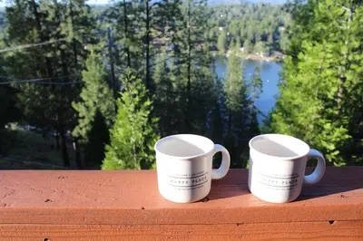 two white coffee mugs sitting on top of a table at Lakeview Yosemite 3B2b Private House - Panoramic Sauna - Seasonal Hot Tub Jacuzzi in Groveland