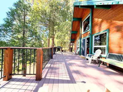 a wooden deck with benches on a building at Rustic and Scenic in Cold Springs