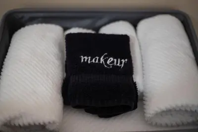 a suitcase with white towels and a black sock at Sleeps 2 Private Entrance, Spa Tub, Near Casino in Tuolumne