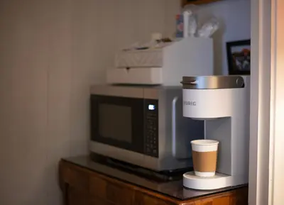 a coffee maker and a coffee cup sitting on a microwave at Sleeps 2 Private Entrance, Spa Tub, Near Casino in Tuolumne