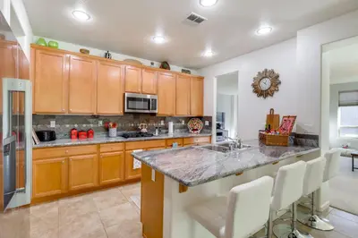 a kitchen with wooden cabinets and a granite counter top at 13 Mi to Slopes Cozy Home with Fenced Yard in Reno in Reno