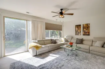 a living room with a couch and a ceiling fan at 13 Mi to Slopes Cozy Home with Fenced Yard in Reno in Reno