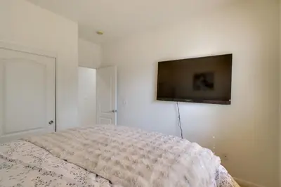 a bedroom with a bed and a flat screen tv on the wall at 13 Mi to Slopes Cozy Home with Fenced Yard in Reno in Reno