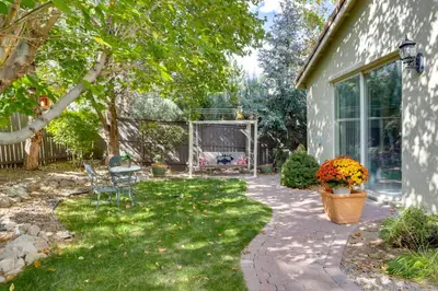 a garden with a patio and a house at 13 Mi to Slopes Cozy Home with Fenced Yard in Reno in Reno