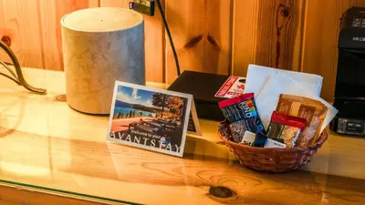 a basket of snacks on a table with a book at Cozy Northstar Village Escape w Forest Views Easy Lift Access Alpineglow Vista by AvantStay in Truckee