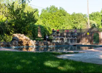 a water feature in a yard with a waterfall at Sac Camp Delta Garden Retreat in Sacramento