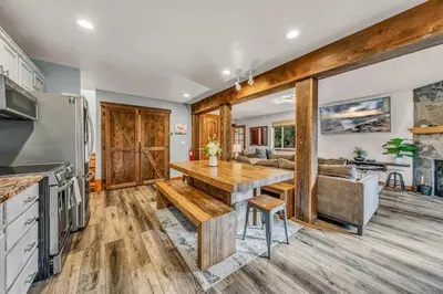 a kitchen and living room with a table and a couch at Kings Beach Retreat Hot Tub & Game Loft in Kings Beach
