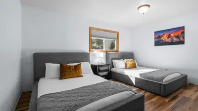 a bedroom with two beds and a window at Steps to Trails Minutes to Heavenly Fireplace Deck BBQ Bluewood Cabin by AvantStay in South Lake Tahoe