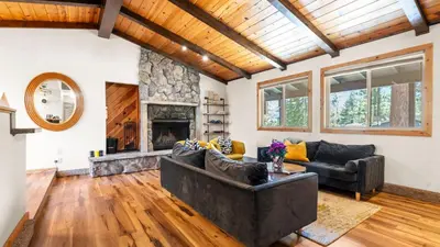 a living room with a couch and a fireplace at Steps to Trails Minutes to Heavenly Fireplace Deck BBQ Bluewood Cabin by AvantStay in South Lake Tahoe