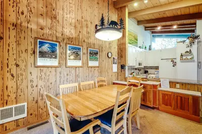 a kitchen and dining room with a wooden table and chairs at Chateau Sans Nom 9 in Mammoth Lakes