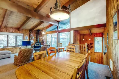 a dining room and living room with a wooden table at Chateau Sans Nom 9 in Mammoth Lakes