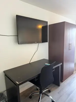 an office with a desk and a tv on the wall at Rancho Cordova Inn in Rancho Cordova