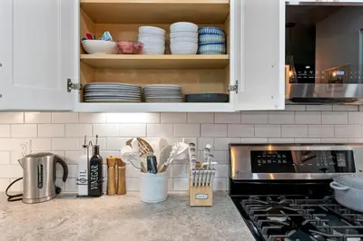 a kitchen with white cabinets with plates and utensils at CYH0883- Patricia's Mountain Paradise home in South Lake Tahoe
