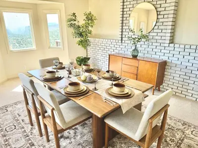 a dining room with a table with chairs and a mirror at Relax Under the Stars, Best view in town , Yosemite House with Firepit, Hot Tub, Game Room & Pool table in Oakhurst