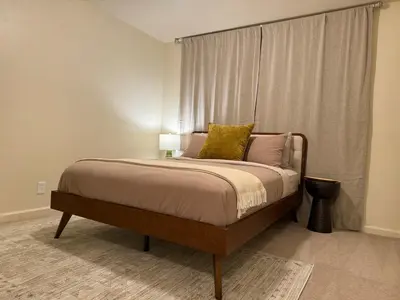 a bedroom with a large bed with a window at Relax Under the Stars, Best view in town , Yosemite House with Firepit, Hot Tub, Game Room & Pool table in Oakhurst