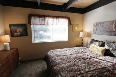 a bedroom with a large bed and a window at HCH0864 - Donner Cabin home in South Lake Tahoe