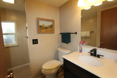 a bathroom with a toilet and a sink and a mirror at HCH0864 - Donner Cabin home in South Lake Tahoe
