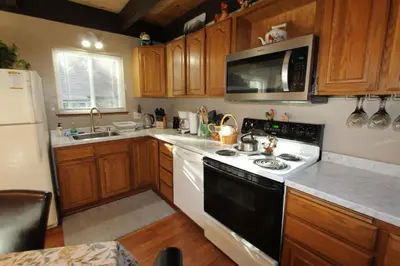 a kitchen with a black and white stove and a microwave at HCH0864 - Donner Cabin home in South Lake Tahoe