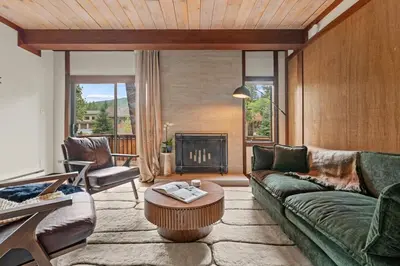 a living room with a green couch and a fireplace at Charming Tahoe Cabin in Incline Village