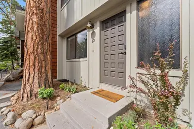 a house with a gray door and a tree at Charming Tahoe Cabin in Incline Village