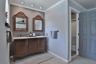 a bathroom with a sink and a mirror at Country Style Mountain Home - View of Lake Forebay in Pollock Pines