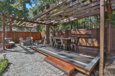 a wooden pergola with a wooden table and chairs at Country Style Mountain Home - View of Lake Forebay in Pollock Pines