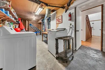 a kitchen with a washing machine and a stool at Peaceful Forest Retreat Near Lake and Town in Tahoe City