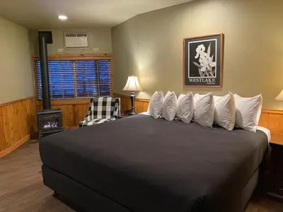 a bedroom with a large bed with white pillows at Timberline Lodge - Arnold - Bear Valley - Murphys in Arnold