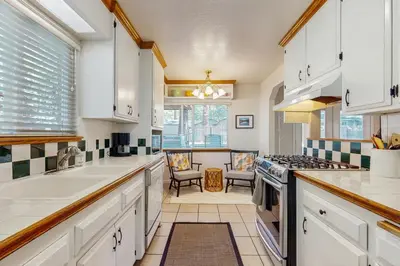 a kitchen with white cabinets and a stove at Golden Pine Lodge in South Lake Tahoe