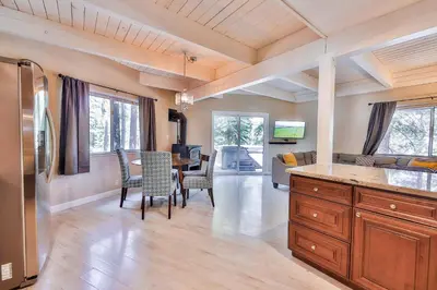 a kitchen and living room with a table and chairs at Iroquois Ridge Hot Tub Near Lake Tahoe & Skiing in South Lake Tahoe