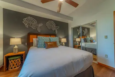 a bedroom with a bed with fish decals on the wall at Posh Village 2/2; Ski-In/Out + Premiere Perks! in Mammoth Lakes