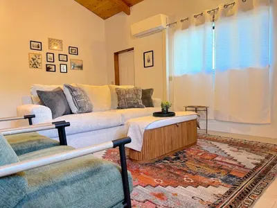 a living room with a couch and a coffee table at NEW LISTING, Near Yosemite South Gate entrance and town, King bed, Hot Tub, BBQ, Firepit & Mountain Views in Oakhurst