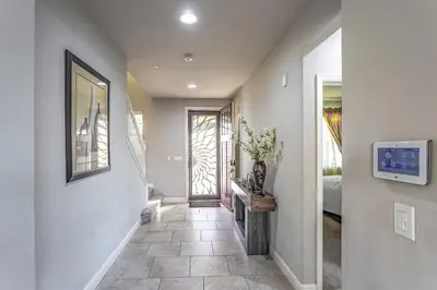 a hallway with a room with a fireplace and a bedroom at Nic's Home in Visalia
