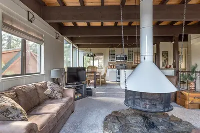 a living room with a couch and a fire place at Modern Rustic Lux Tahoe Cabin in Carnelian Bay