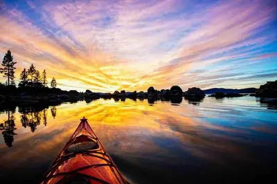 a kayak on a lake at sunset at Modern Rustic Lux Tahoe Cabin in Carnelian Bay
