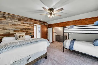 a bedroom with two beds and a ceiling fan at Wooded Getaway Steam Shower plus Hot Tub in Tahoe City