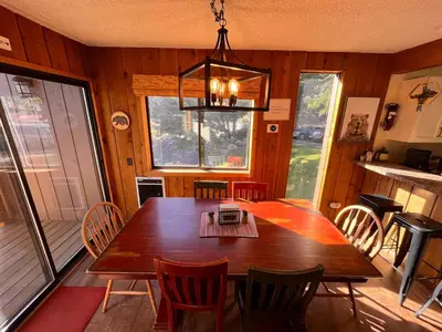 a dining room with a wooden table and chairs at Cozy Walk-to-Lifts Mammoth Condo with Hot Tub in Mammoth Lakes