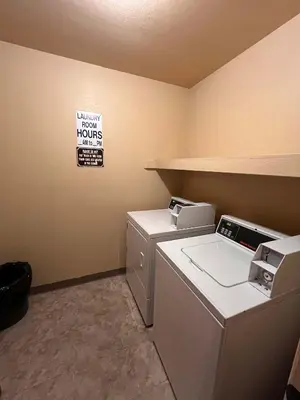 a laundry room with a washer and dryer and a sign at Cozy Walk-to-Lifts Mammoth Condo with Hot Tub in Mammoth Lakes