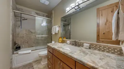 a bathroom with a sink and a shower and a toilet at Cozy Tahoe Retreat w Hot Tub Movie Room Forest Views 10th ave 2 by AvantStay in Tahoma