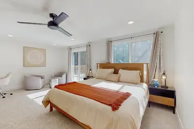 a bedroom with a large bed and a ceiling fan at The Pine Chalet in South Lake Tahoe
