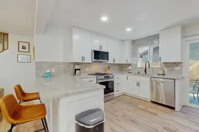 a kitchen with white cabinets and a counter top at The Pine Chalet in South Lake Tahoe