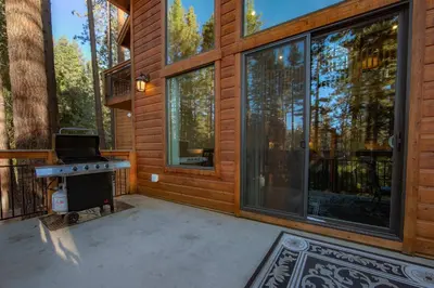 a screened in porch of a house with a stove at The T-Pot Chalet for 12 in South Lake Tahoe