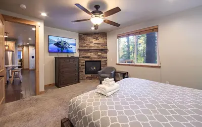 a bedroom with a large bed and a fireplace at The T-Pot Chalet for 12 in South Lake Tahoe