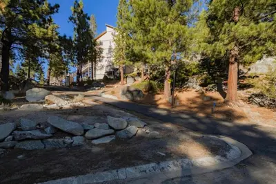 a yard with a stone wall and a house at Galaxy Way Close to Stagecoach Chair in Stateline