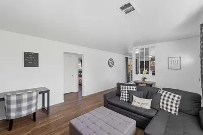 a living room with a couch and a table at The Cozy Rustic Sequoia Wi-Fi & 2 Garage in Tulare