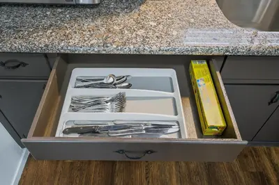 a drawer in a kitchen with utensils in it at The Cozy Rustic Sequoia Wi-Fi & 2 Garage in Tulare