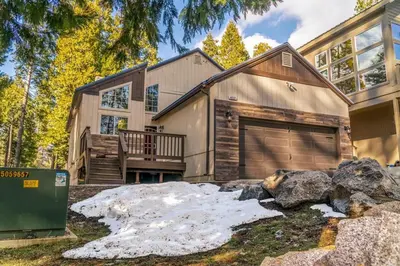 a house with a garage in front of it at Halonas Cozy Cabin 2M To Lake in Shaver Lake